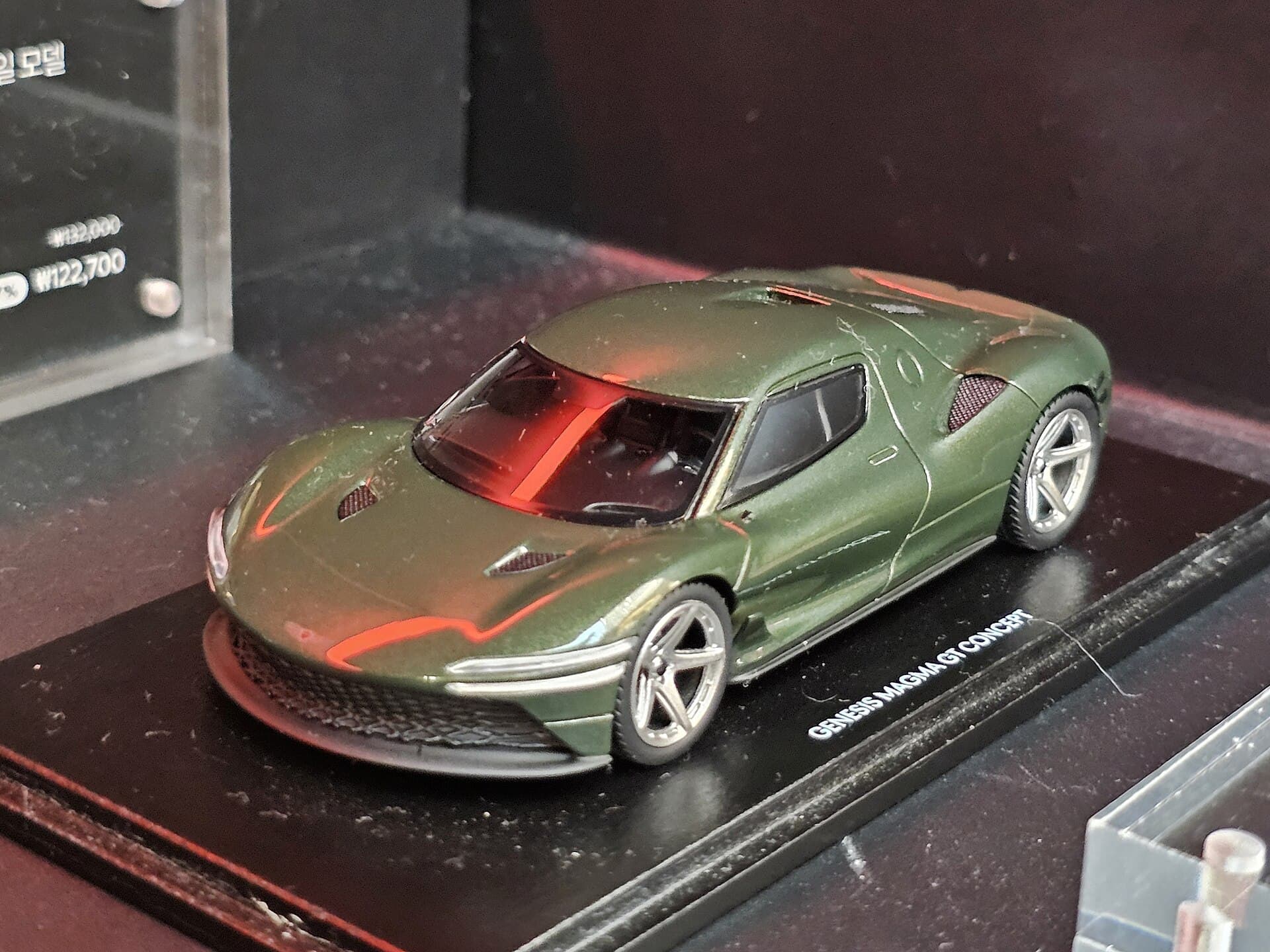 A scale model of the orange Genesis Magma GT concept supercar on display